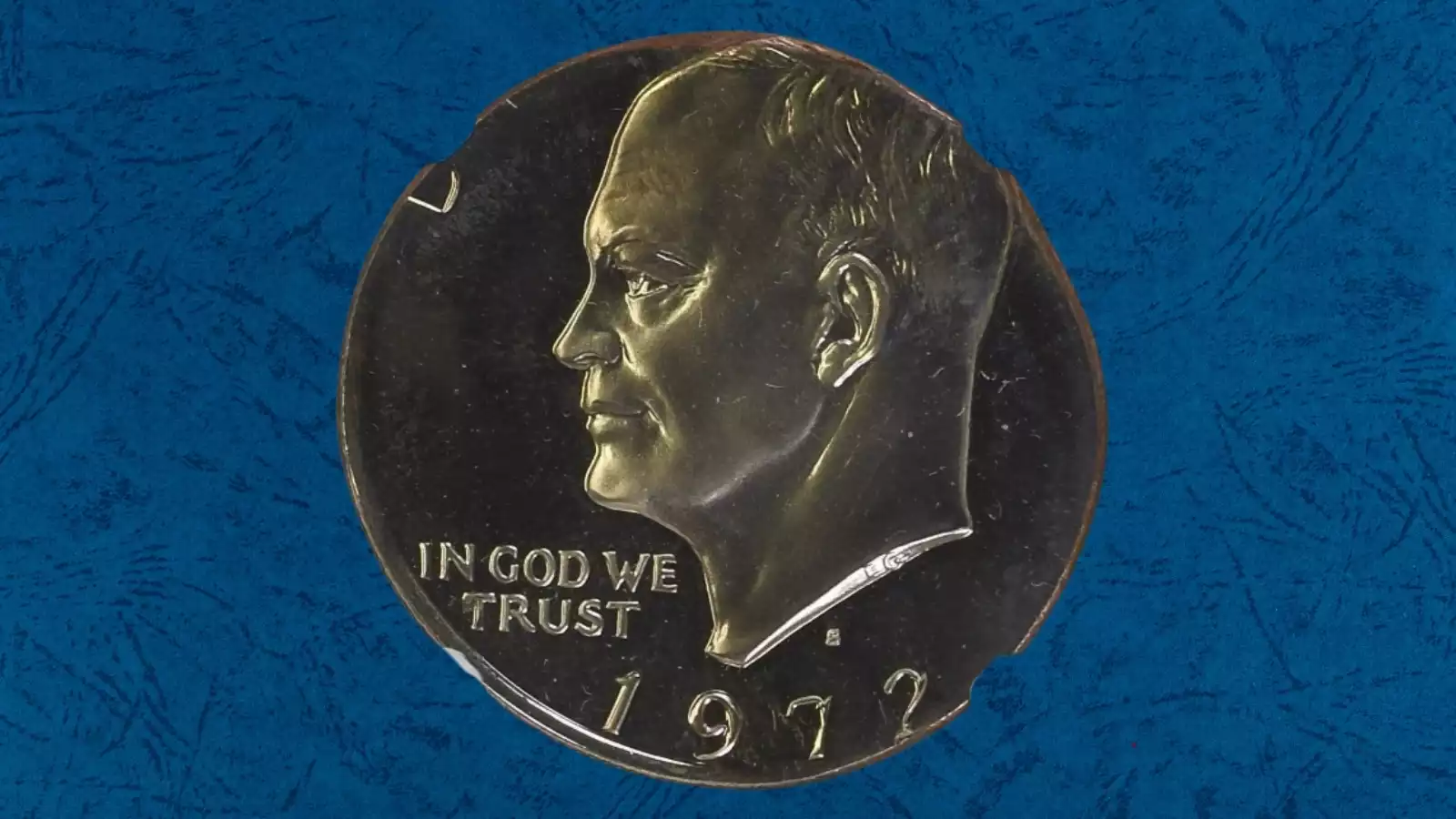 1972 Eisenhower dollar wrong planchet error struck on Kennedy half dollar blank showing design overflow beyond planchet edge